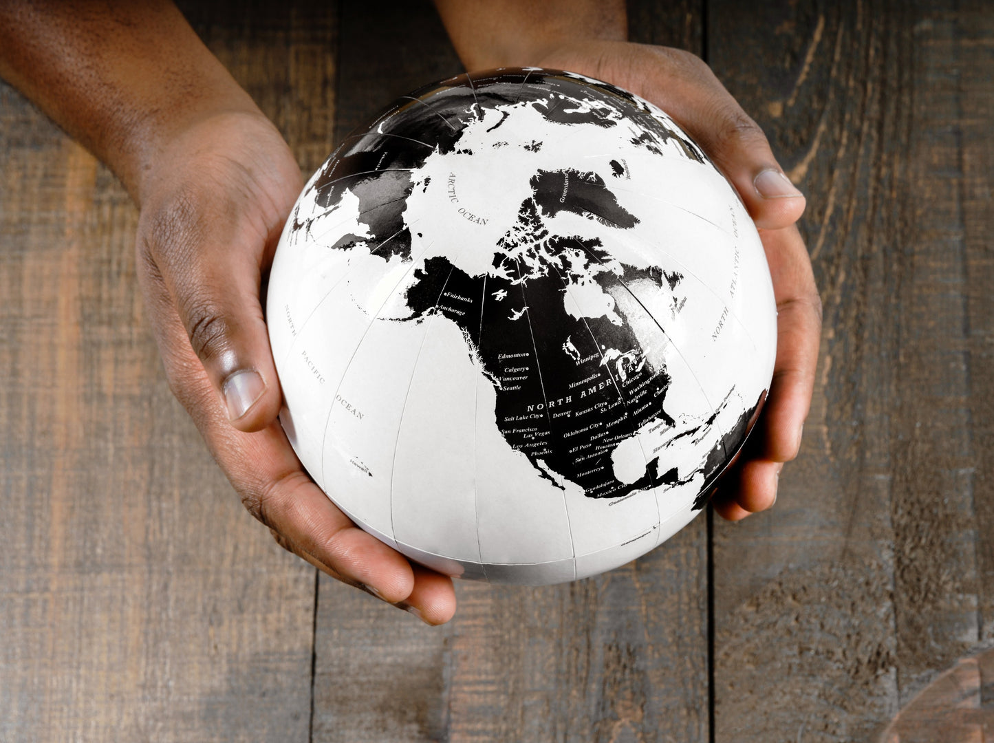 Hands holding a globe